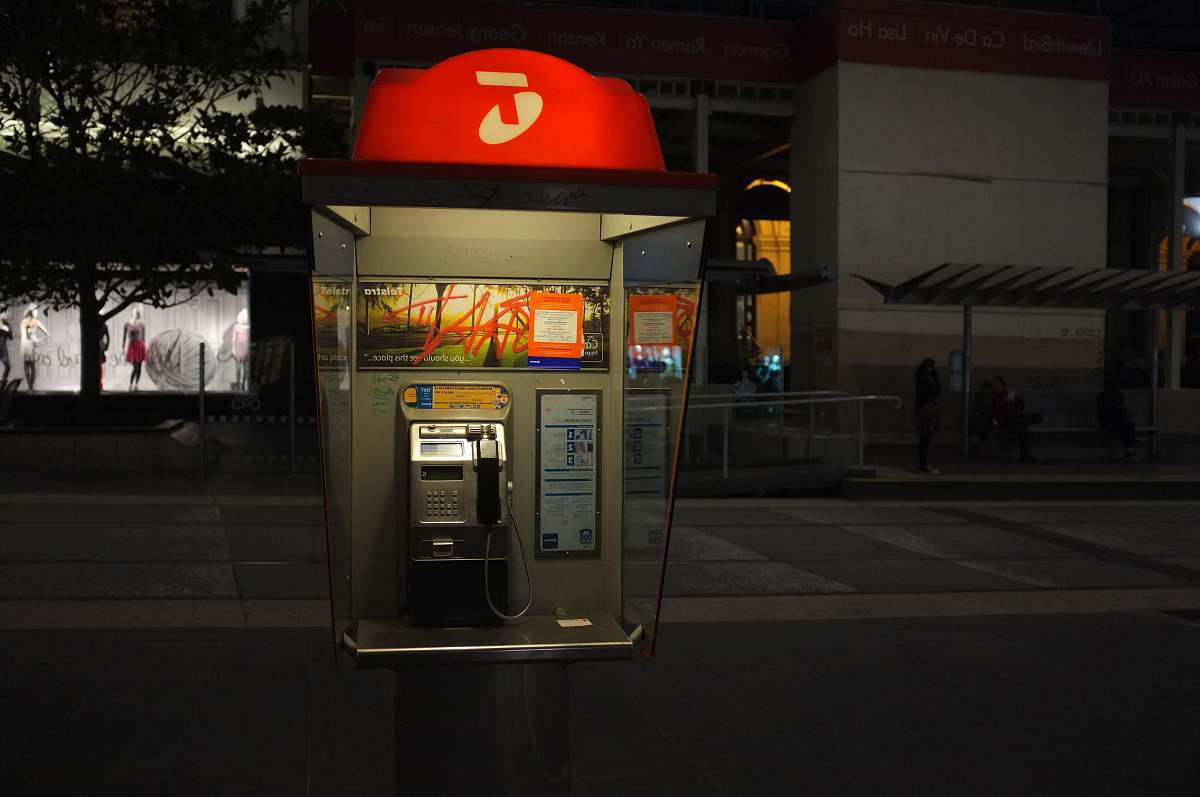 window display gray and red telephone post on street melbourne